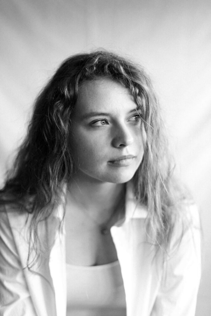 Woman looking thoughtfully into the distance, representing calm and clarity after anxiety work